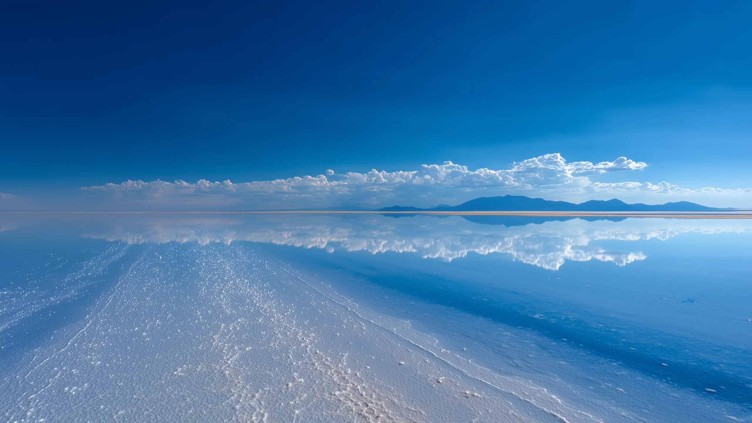 Salar de Uyuni at midday, deep blue sky and white salt